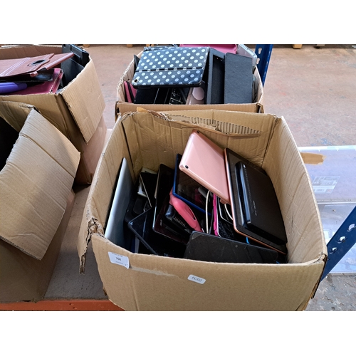 768 - Two boxes, one containing tablet cases and one containing technology items and damaged tablets to in... 