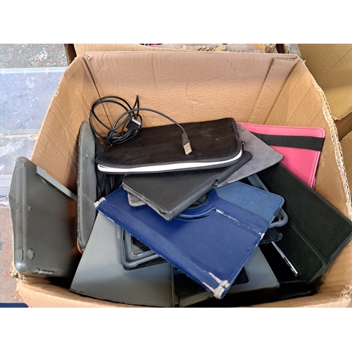 768 - Two boxes, one containing tablet cases and one containing technology items and damaged tablets to in... 