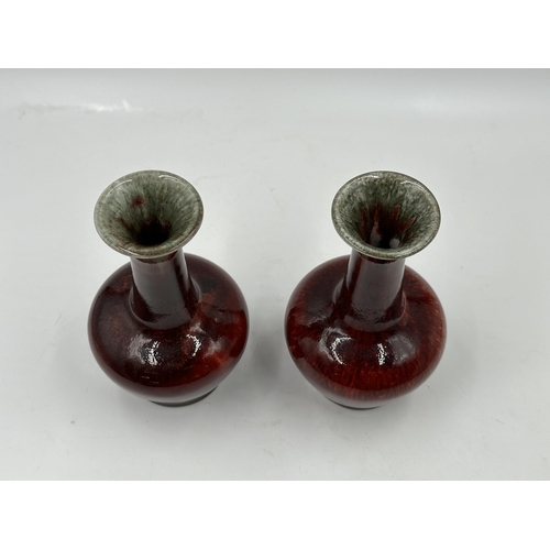 321 - A pair of Cobridge Stoneware Flambé bottle neck vases - approx. 15cm high