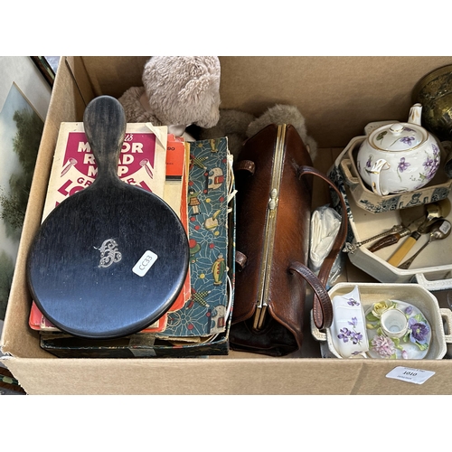 1010 - A box containing items to include hallmarked Sheffield silver teaspoon, ebony hand mirror with silve... 