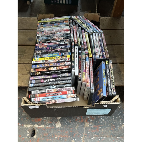 929 - A box containing adult DVDs