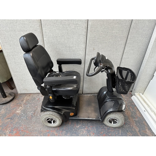 823 - A Strider ST4D mobility scooter with key and charger (key in office)