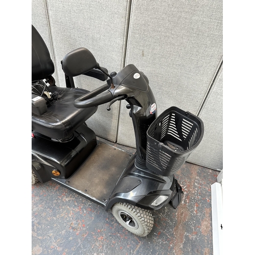 823 - A Strider ST4D mobility scooter with key and charger (key in office)