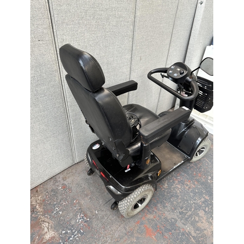 823 - A Strider ST4D mobility scooter with key and charger (key in office)