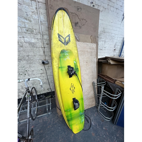 864 - Two items, one surfboard - approx. 230cm long and one JXT wakeboard - approx. 154cm long