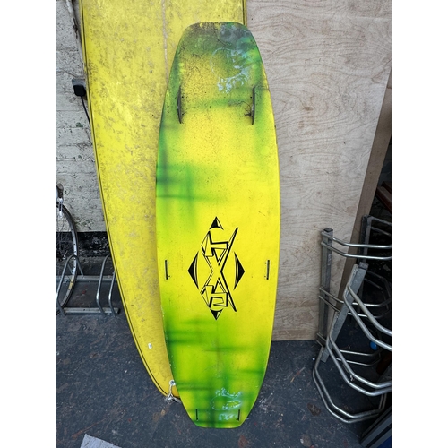 864 - Two items, one surfboard - approx. 230cm long and one JXT wakeboard - approx. 154cm long