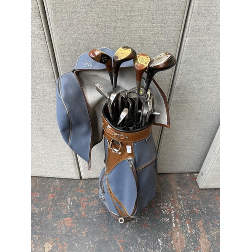 871 - A golf bag containing golf clubs to include Toney Penna, Aldridge HB&S Pinseeker, PGF Status Mk. III... 