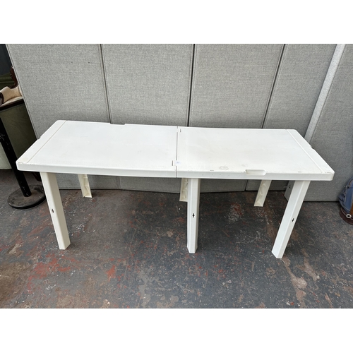 872 - A white plastic folding table - approx. 60cm wide x 180cm long