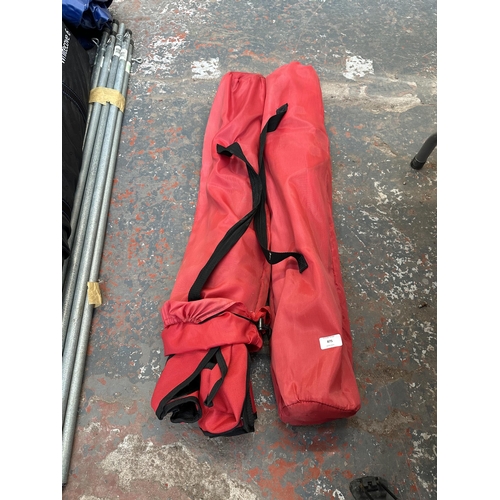 875 - Two bagged red fabric folding camping chairs