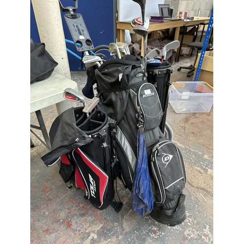 877 - Three Dunlop golf bags containing clubs to include Max Faulkner, Dunlop etc.