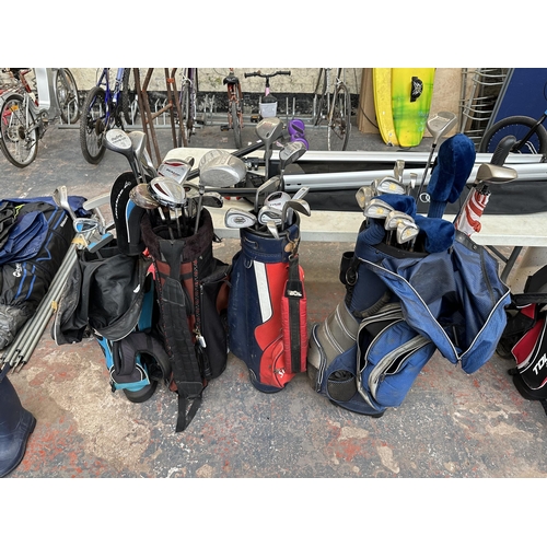 878 - Four golf bags containing clubs to include Dunlop, Shear-Line, MacGregor etc.