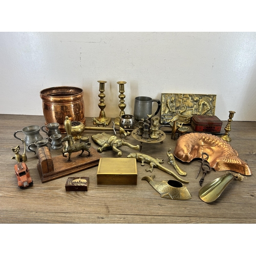 436 - A collection of metalware to include copper fish jelly mould, pair of brass candlesticks etc.