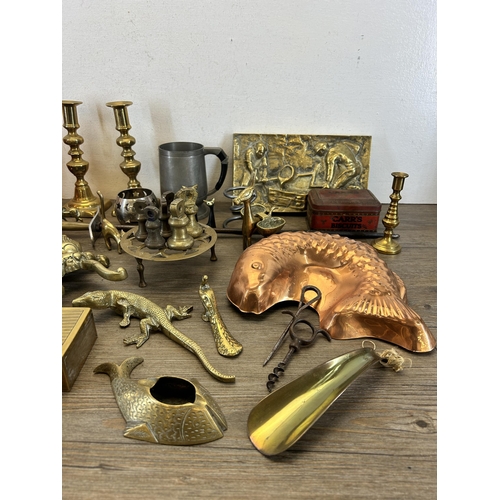 436 - A collection of metalware to include copper fish jelly mould, pair of brass candlesticks etc.