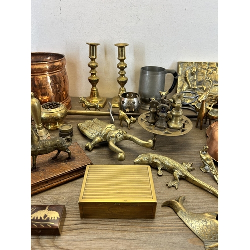 436 - A collection of metalware to include copper fish jelly mould, pair of brass candlesticks etc.