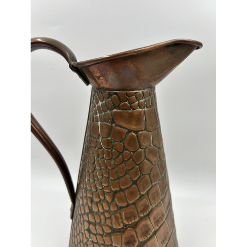 438 - A Joseph Sankey & Sons copper lizard skin pattern jug - approx. 27cm high