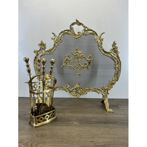 441 - Two pieces of brassware, one Rococo style fire guard - approx. 63cm high x 65cm wide and one compani... 