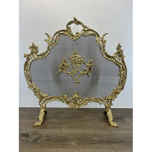 441 - Two pieces of brassware, one Rococo style fire guard - approx. 63cm high x 65cm wide and one compani... 