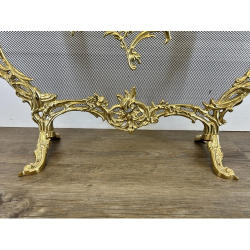 441 - Two pieces of brassware, one Rococo style fire guard - approx. 63cm high x 65cm wide and one compani... 