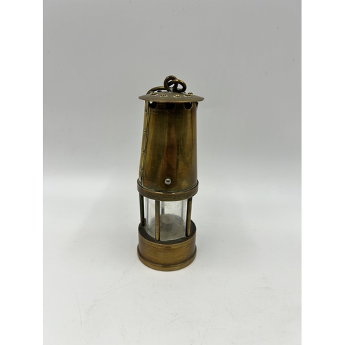 442 - A miniature brass miner's lamp - approx. 13cm high