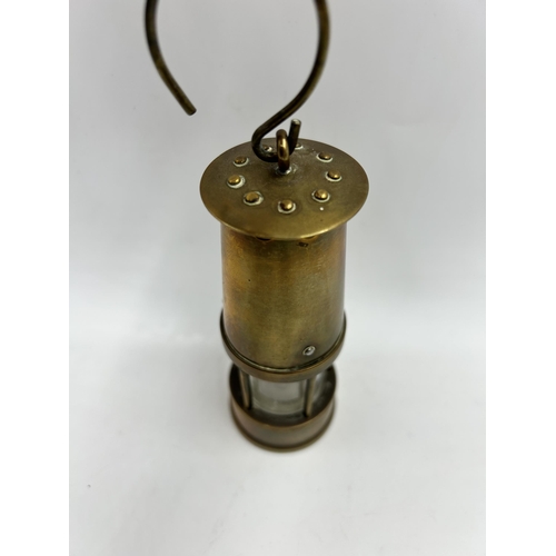 442 - A miniature brass miner's lamp - approx. 13cm high