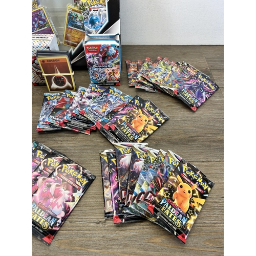 450 - A collection of Pokemon trading cards to include Scarlett & Violet Paldean Fates Elite trainer box, ... 