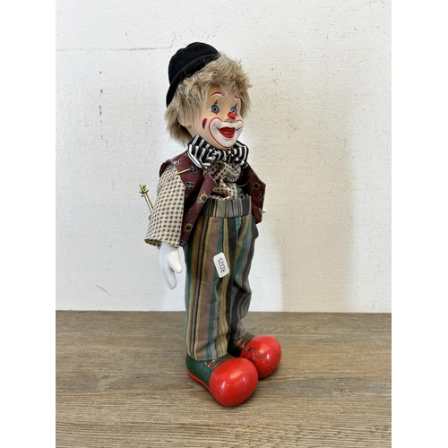 463C - Two vintage clockwork and porcelain clown figurines