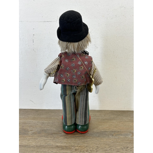 463C - Two vintage clockwork and porcelain clown figurines