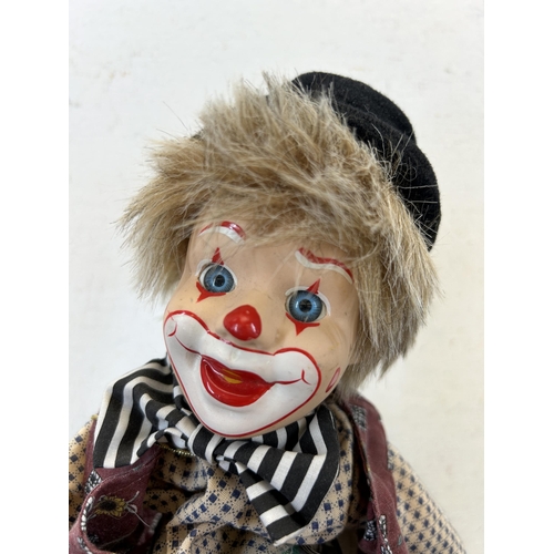 463C - Two vintage clockwork and porcelain clown figurines