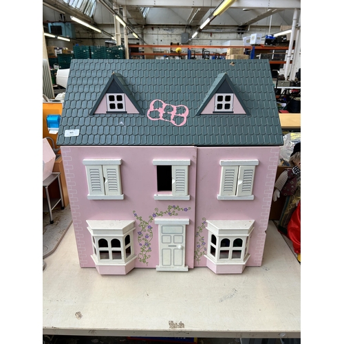 465 - A three storey dolls house with furniture