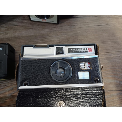 611 - A collection of vintage cameras to include Holga 120S for 120 film, Konica Pop, Kodak 'Brownie' 127,... 