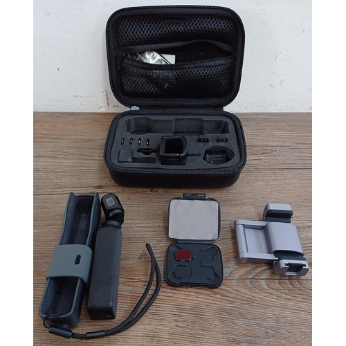 616 - A cased DJI Osmo Pocket OTI10 4K Ultra HD handheld gimbal camera with accessories