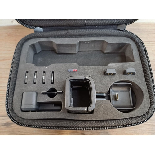 616 - A cased DJI Osmo Pocket OTI10 4K Ultra HD handheld gimbal camera with accessories