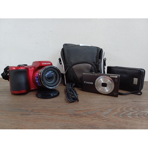 618 - Two cased digital cameras, one Samsung WB100 16.2mp and one Canon PowerShot A2400IS 16mp