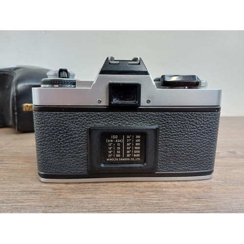 619 - A cased Minolta XG-1 35mm SLR camera fitted with MD 50mm 1:1.7 lens