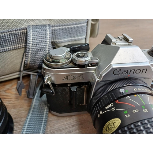 627 - A camera case containing Canon A-1 35mm SLR camera fitted with FD 50mm 1:1.8 lens, Canon AE-1 35mm S... 