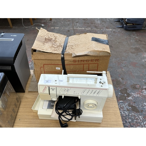 803 - A Singer Melodie 20 electric sewing machine with foot pedal and instruction manual