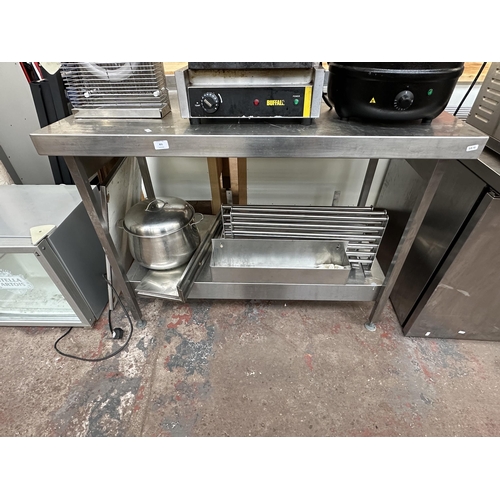 831 - A stainless steel catering worktable with large lidded saucepan etc.