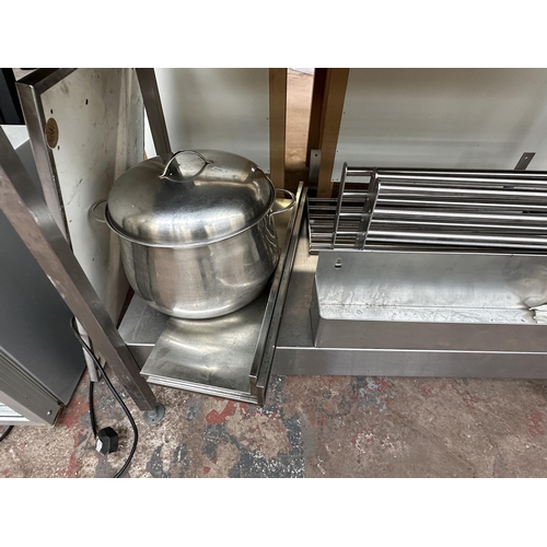 831 - A stainless steel catering worktable with large lidded saucepan etc.