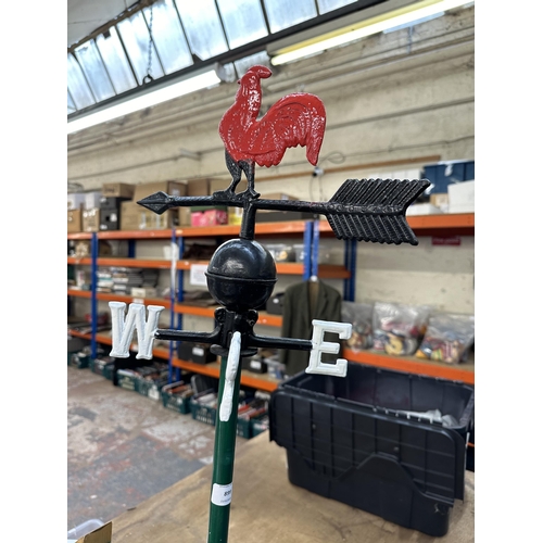 A cast metal weathervane on wooden stand - approx. 89cm high