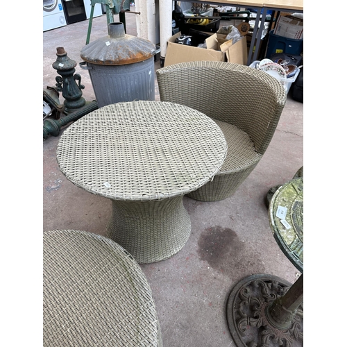 920 - A plastic rattan effect three piece patio set comprising circular table and two chairs - table appro... 