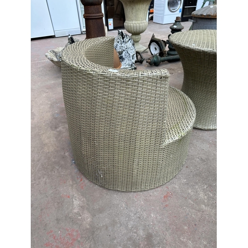 920 - A plastic rattan effect three piece patio set comprising circular table and two chairs - table appro... 