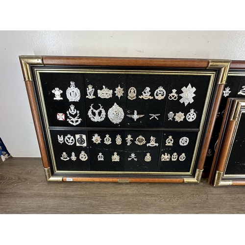 2232D - Three mahogany and gilt metal framed collections of military cap badges