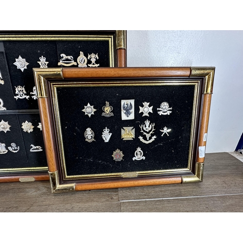 2232D - Three mahogany and gilt metal framed collections of military cap badges