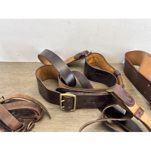 2232O - A collection of military leather belts