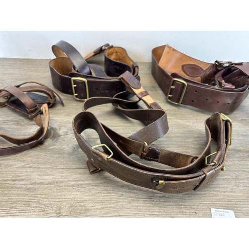 2232O - A collection of military leather belts