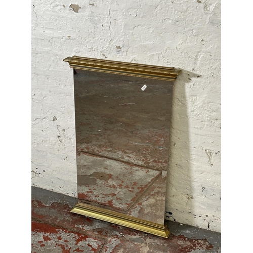 251 - A gilt framed bevelled edge wall mirror - approx. 80cm high x 52cm wide