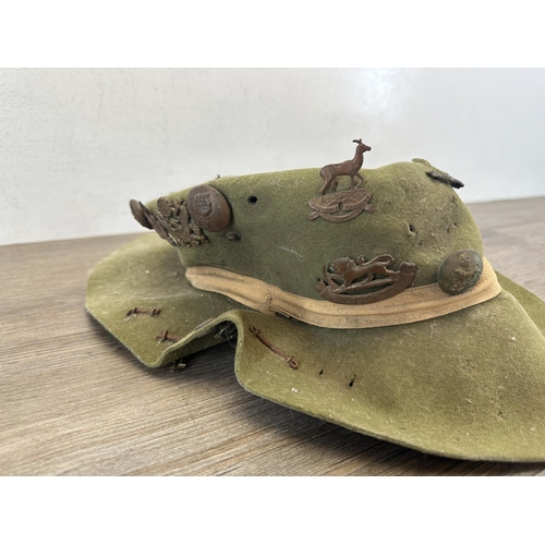 2233T - A military slouch hat with fitted cap badges to include South Staffordshire, Imperial Service, Royal... 