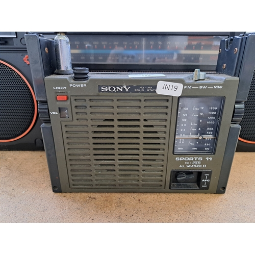 689 - Two items, one Sony ICF-111B Sports 11 three-band solid-state all-weather portable radio and one Phi... 