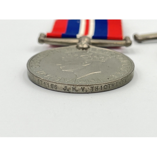 2232 - Two WWII British medals, one War presented to 571166 J. H. V. Thicthener and one Defense