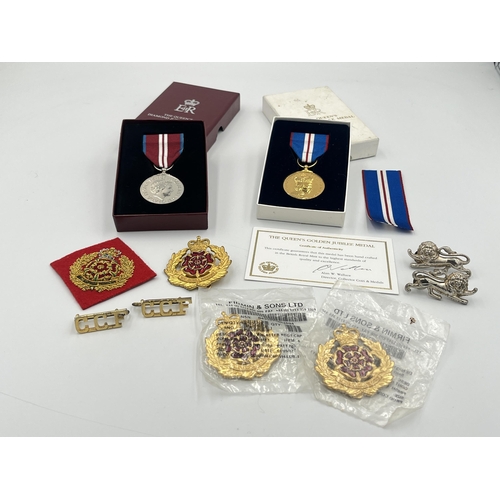 2232C - A collection of medals and badges to include a boxed Royal Mint The Queen's Golden Jubilee medal wit... 